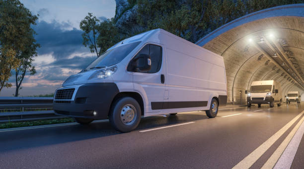 Several Delivery Vans Passing through a Tunnel stock photo