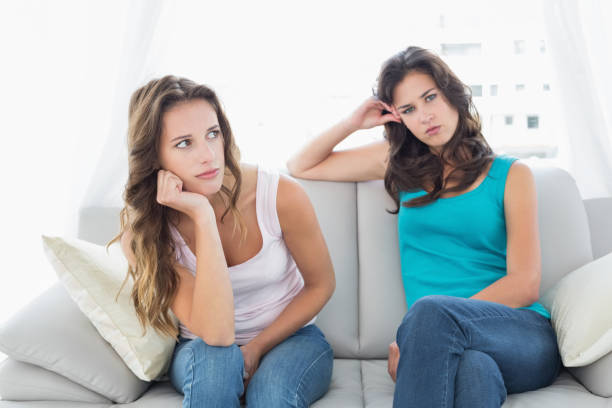 istock Unhappy friends not talking after argument at home 869548072