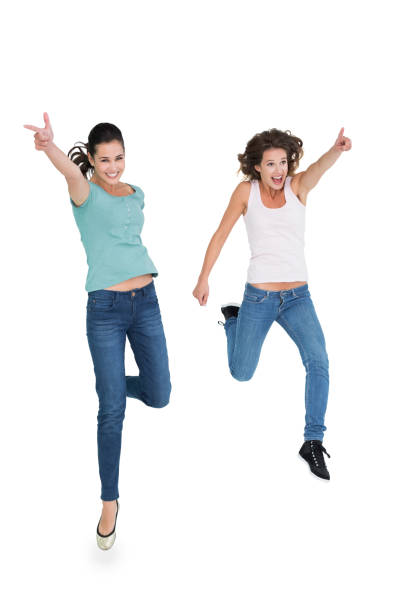 istock Two cheerful young female friends with hand gestures 869550942