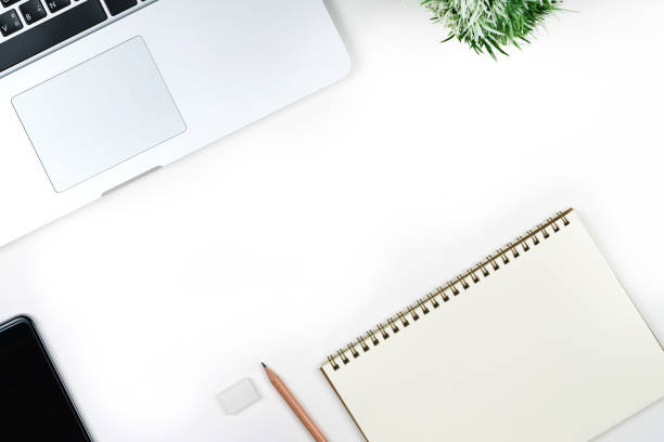 istock Business office work desk table with computer laptop , note and stationery on white table background include copyspace for add text or graphic 869550964