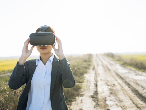 woman using a Virtual reality simulator at countryside.
