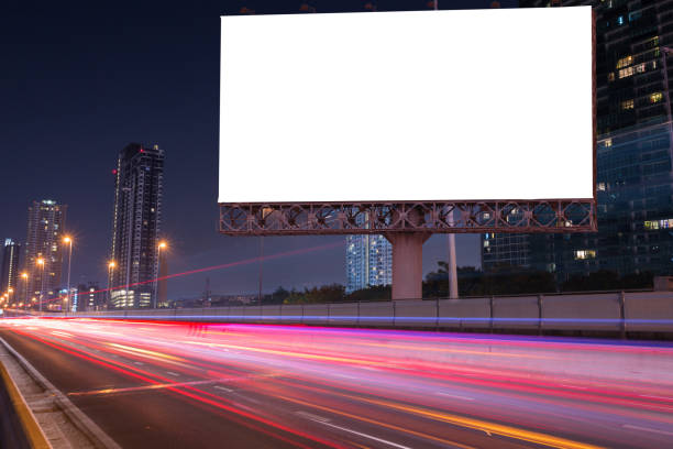 istock Blank billboard on light trails, street and urban in the night - can advertisement for display or montage product or business. 869558232