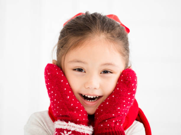 istock happy little girl in winter clothes 869564310