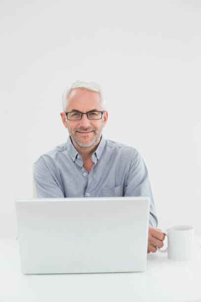 istock Businessman with laptop and coffee cup 869570394
