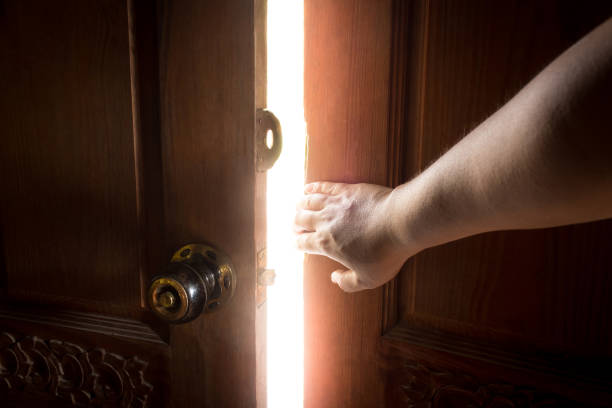istock Use your hand to open the door to the light. 869570448