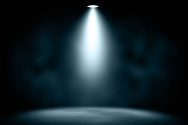 istock blue spotlight smoke studio entertainment background. 869570474