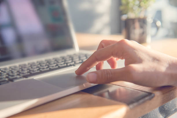 istock Woman hand using touchpad on laptop at home 869576670