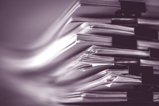 istock extreamly close up  the stacking of office working document with paper clip folder, vintage color tone 869577468