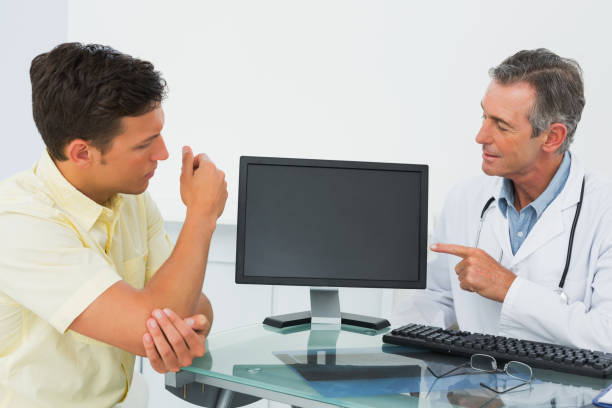 istock Doctor in conversation with patient in office 869577812
