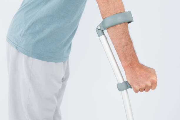 istock Closeup mid section of a man with crutch 869580892