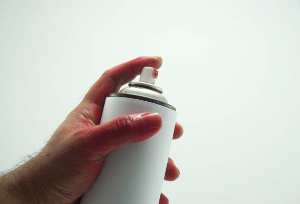 istock Man's hand hold spray bottle isolated on white background 869580976