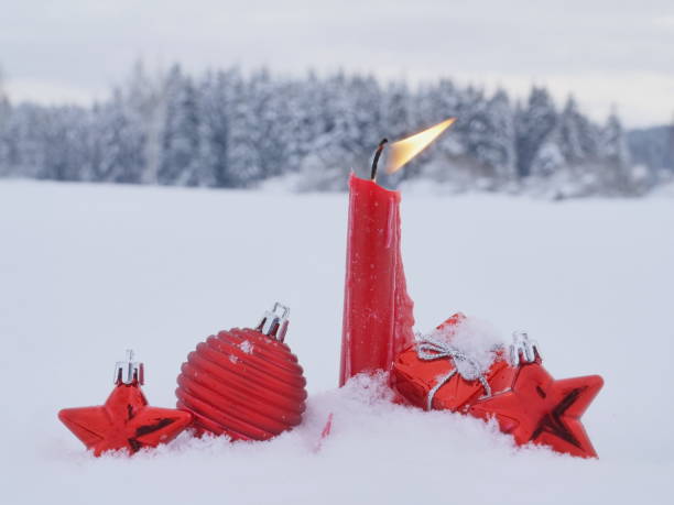 istock Christmas candle snow 869584428