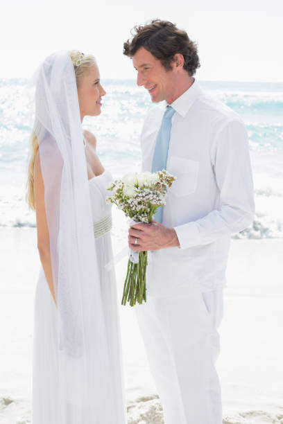 istock Bride and groom smiling at each other 869585054