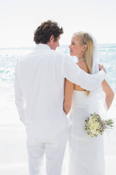 istock Happy bride and groom looking at each other 869585066
