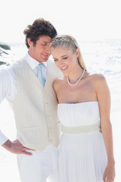 istock Attractive bride and groom embracing 869585188