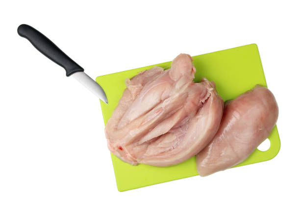 istock A plastic kitchen cutting board with chicken breast. There is an operation to separate the fillets from the bones. 869585246