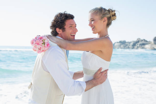 istock Laughing groom picking up his pretty wife 869587526