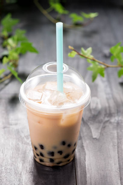 istock Bubble boba tea with milk and tapioca pearls in plastic cup 869594696