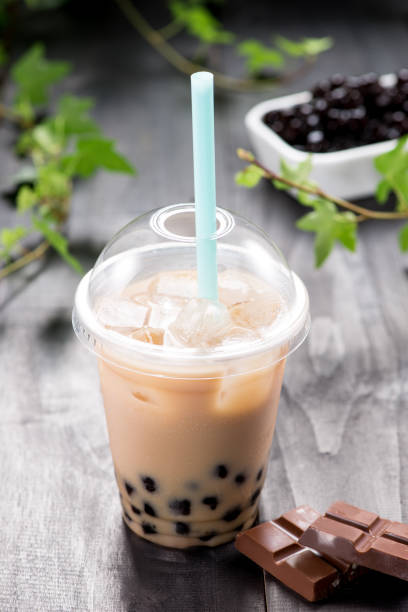 istock Homemade chocolate milk bubble tea in plastic cups on table. 869594848