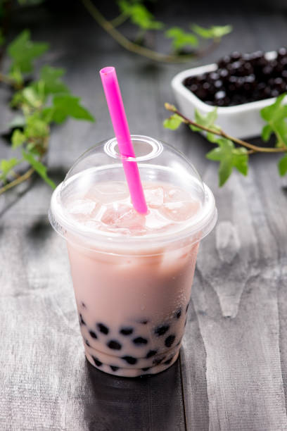 istock Bubble boba tea with milk and tapioca pearls in plastic cup 869594888