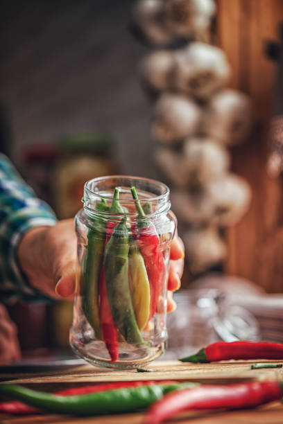 istock Preserving Organic Chili Peppers in Jars 869598596