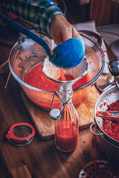 istock Preparing Homemade Tomato Sauce and Preserving in Bottles 869598688
