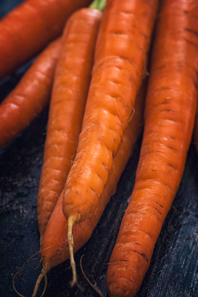 istock Organic Bunch of Carrots on Rustic Background 869599006