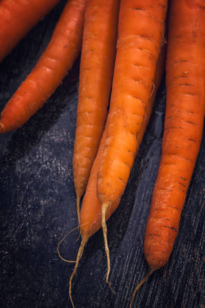 istock Organic Bunch of Carrots on Rustic Background 869599018