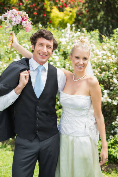 istock Romantic newlywed couple smiling at camera 869599184
