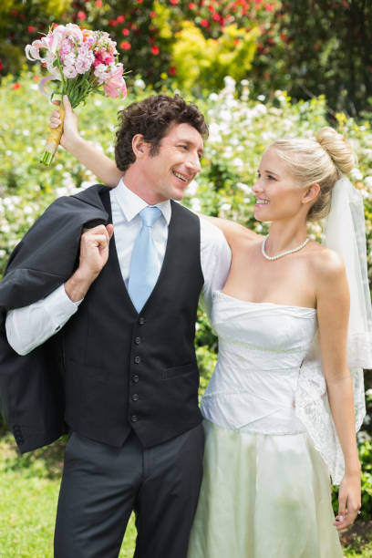 istock Romantic newlywed couple smiling at each other 869599212