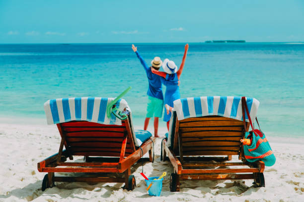istock happy couple relax on a tropical beach 869599238