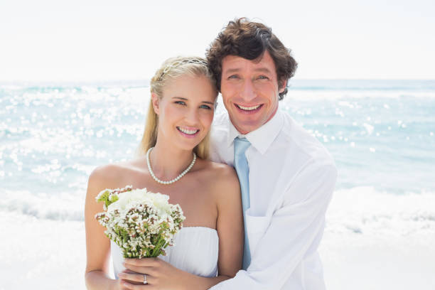 istock Romantic couple on their wedding day smiling at camera 869599344
