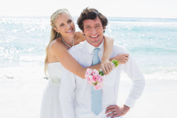 istock Cute couple on their wedding day smiling at camera 869599352