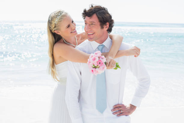 istock Cute couple on their wedding day smiling at each other 869599366