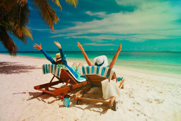 istock happy couple relax on a tropical beach 869599522