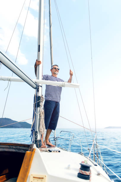 istock Man enjoying sailing with sailboat 869600118