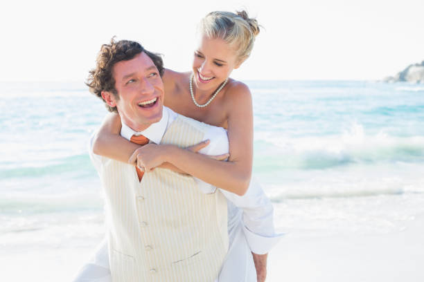 istock Smiling bride getting a piggy back from new husband 869602670