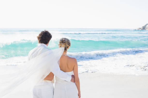 Newlyweds looking out to sea together