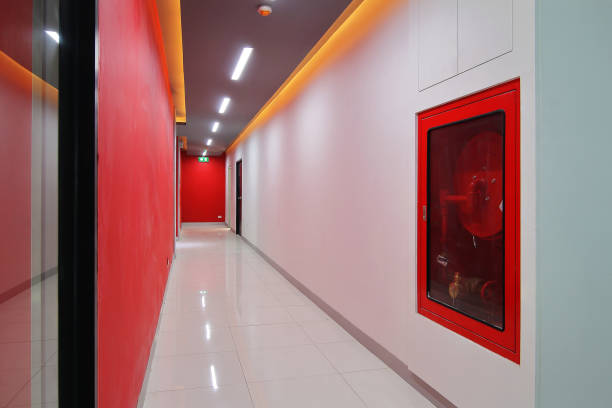 istock Emergency exit of the building with fire exit sign,fire alarm and Fire extinguisher 869603014