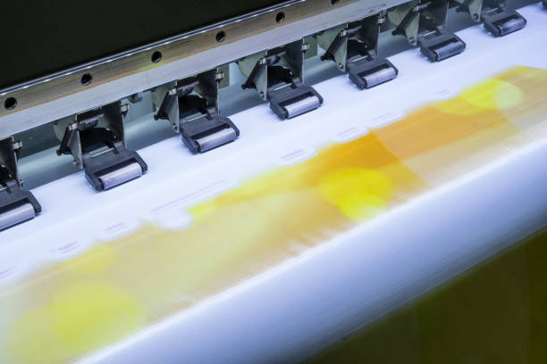 istock Close up inkjet printer working on vinyl banner 869606530