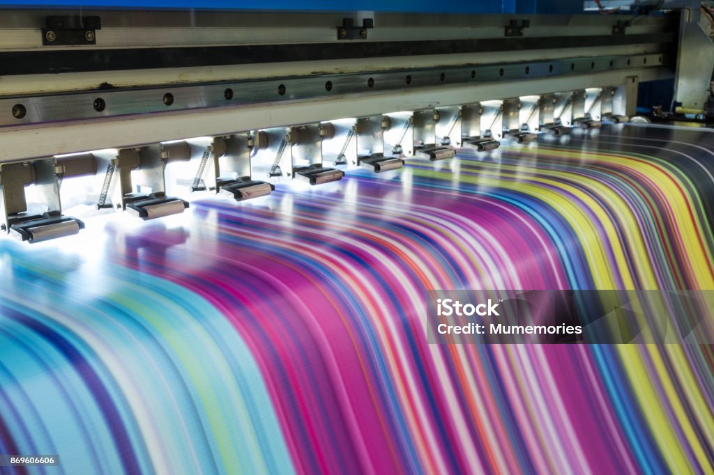 Large inkjet printer working multicolor on vinyl banner Large inkjet printer working multicolor cmyk on vinyl banner Printing Out Stock Photo
