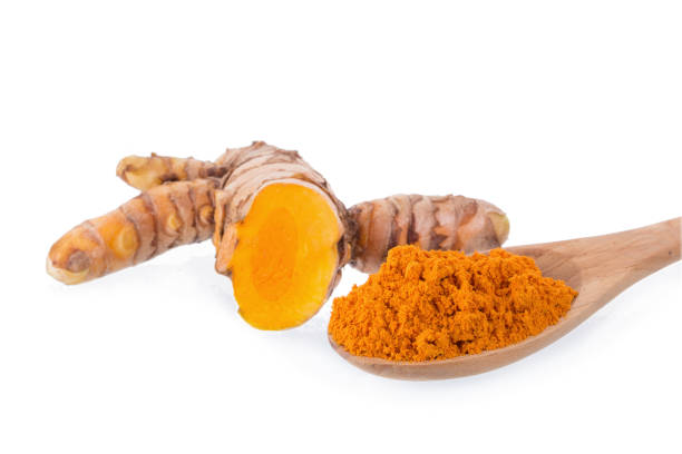 istock Turmeric powder and Fresh turmeric slices isolated on white background 869618900