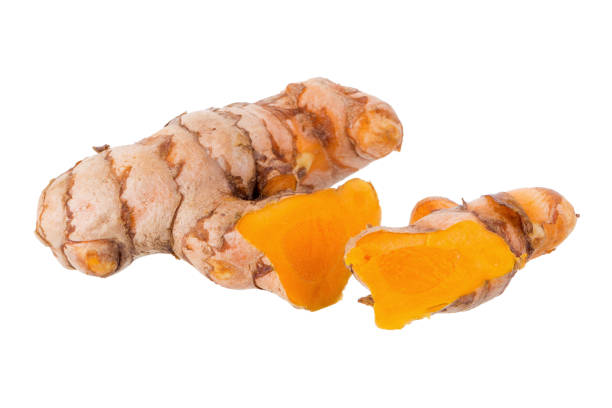 istock Fresh turmeric slices isolated on white background 869618904