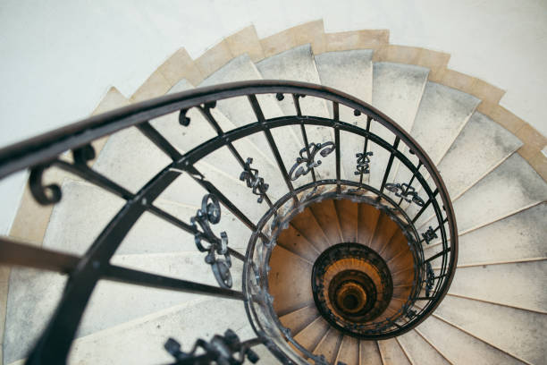 istock spiral stairs in old house 869619922