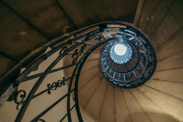 istock spiral stairs in old house 869621932
