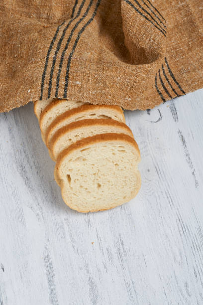 istock Freshly baked bread on white wooden table with Tablecloth and copy space 869622276
