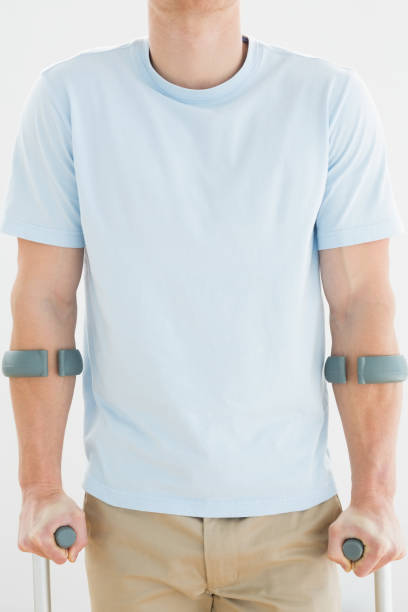 istock Closeup mid section of a man with crutches 869626720