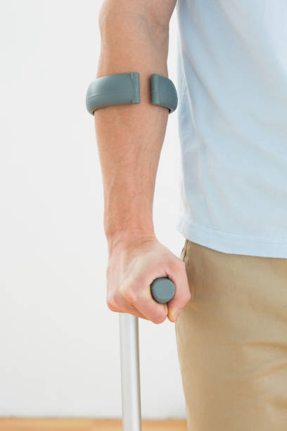 istock Closeup mid section of a man with crutch 869626728