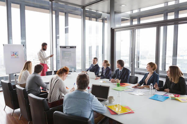 istock Hipster business man presenting the project in modern office. 869626866