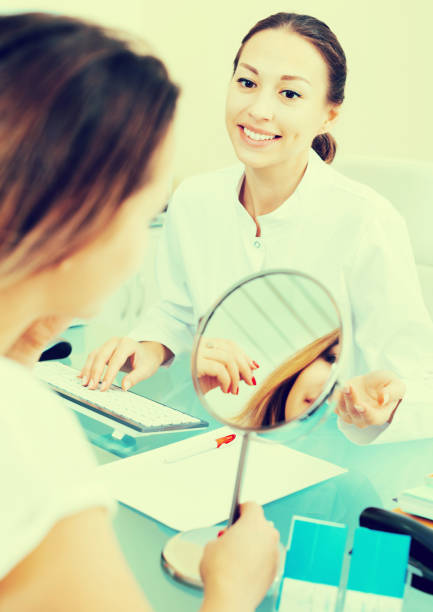 istock Woman client checking result of beauty procedures 869637224